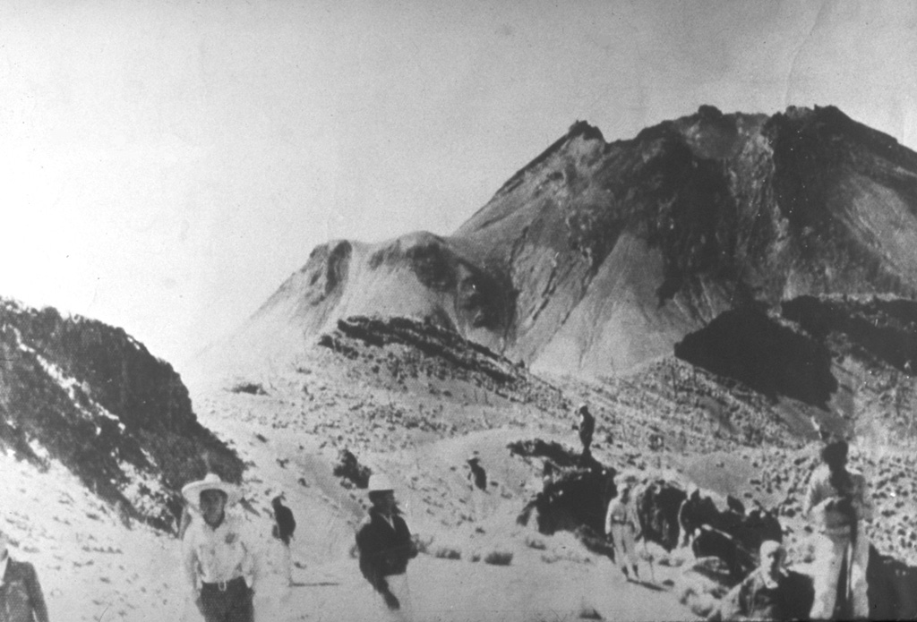 The powerful 1913 explosive eruption at Colima removed about 100 m of the summit and created a large 450-m-wide crater. The jagged 1913 crater rim is seen here in 1936 from Nevado de Colima. Lava had partially filled the 350-m-deep crater, but did not overflow the rim until 1961. El Volcancito, the lava dome created in 1869, is the feature on the left side of the cone. Photo courtesy Julian Flores (University of Guadalajara), 1936.
