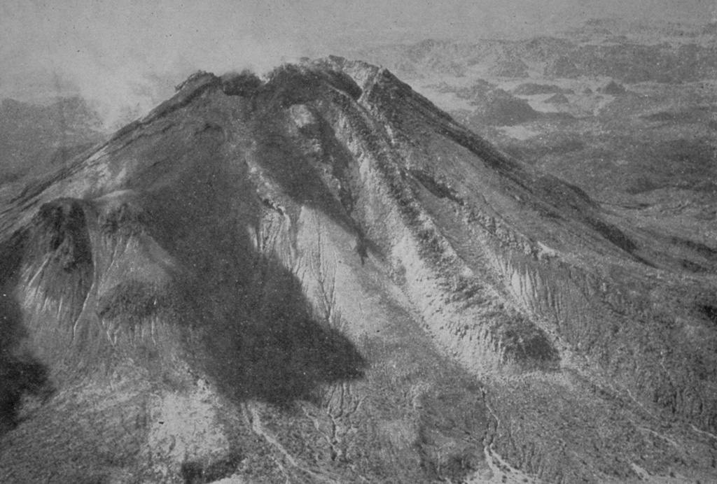 Renewed growth of the lava dome in the summit crater began in 1957. By the time of this aerial photo from the NE in 1961, lava had spilled over a notch in the northern crater rim and produced the lava flow seen here descending the northern flank to the lower right. By the end of 1962 the flow had traveled 1 km from the summit, reaching the caldera floor. Photo from Mooser and Maldonando-Koerdell 1961 (XIIIth General Assembly IUGG).