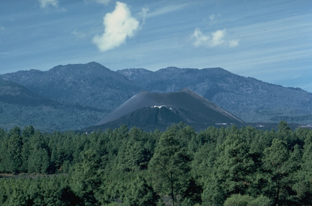 Parícutin, the volcano that erupted in cornfield in 1943, is the best-known feature of the Michoacán-Guanajuato volcanic field. The huge field contains over 1,400 vents covering a wide area of Michoacán and Guanajuato states. Scoria cones are the predominant volcanic form, and lava domes, maars, tuff rings, and lava flows are also present. Parícutin is seen here from the NE with Cerro de Tancítaro in the background. Photo by James Allan, 1985 (Smithsonian Institution).