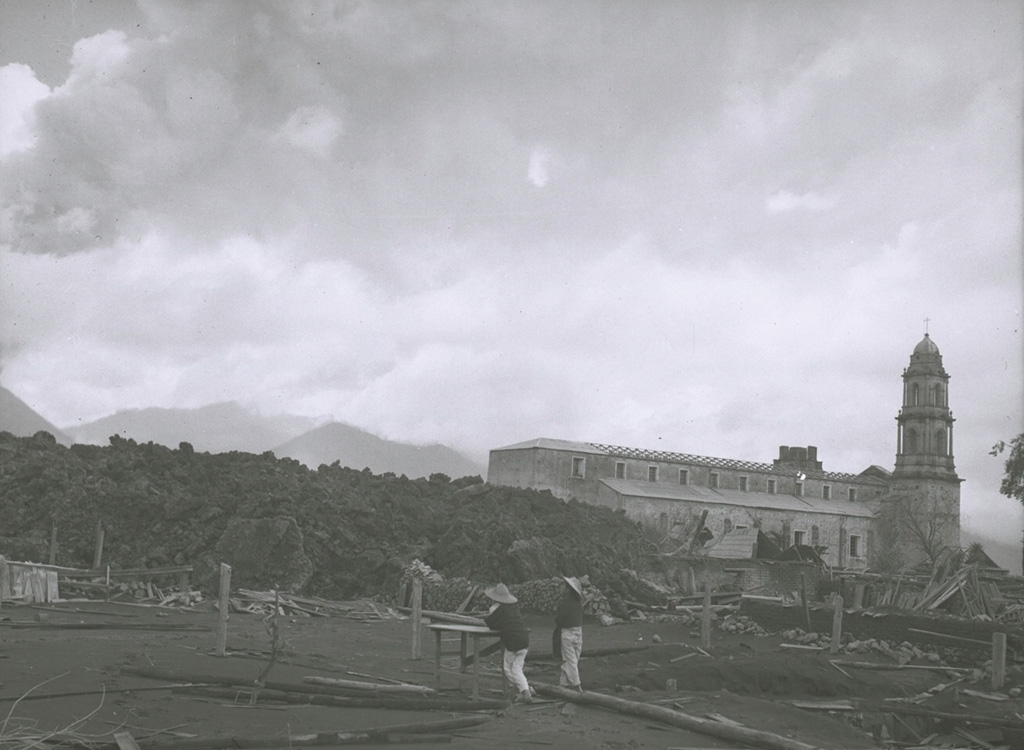 On 7 July 1944 a lava flow (left) approaches the church of San Juan Parangaricutiro. Residents had already evacuated the town when lava first entered the town on 17 June. By the time the flow stopped in early August the church was entirely surrounded by lava. Photo by William Foshag, 1943 (Smithsonian Institution, published in Luhr and Simkin, 1993).