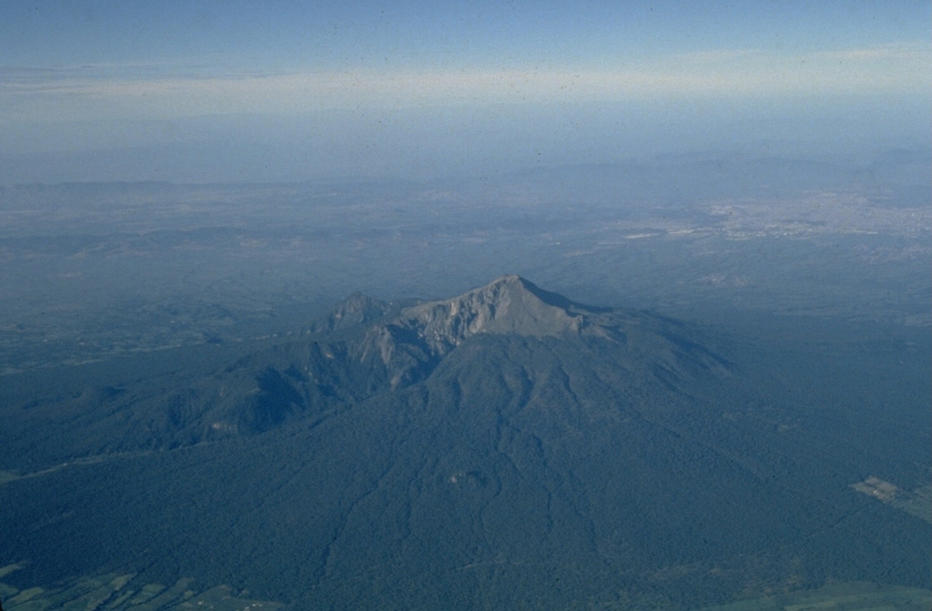 Volcán la Malinche, seen here in an aerial view from the NE, is an eroded edifice with deep canyons from glacial erosion, located NE of the city of Puebla and between the Popocatépetl-Iztaccíhuatl and Orizaba-Cofre de Perote volcanic ranges. Much of the edifice was constructed during the Pleistocene but there are Holocene tephra layers of Holocene age. Photo by Steve Nelson, 1987 (Tulane University).