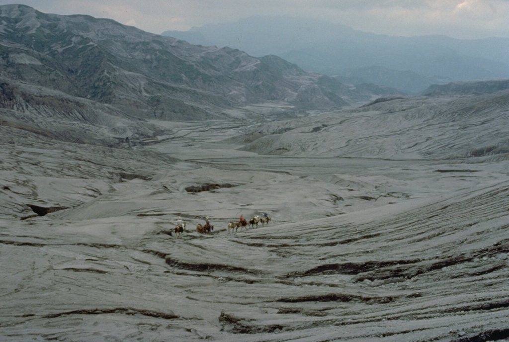 A geological field party on horseback rides through the area devastated by pyroclastic surges during the 1982 eruption of El Chichón.  Pyroclastic flows and surges swept a roughly circular area of about 150 sq km radially from the summit to distances up to 8.5 km from the vent.  Nine villages were within the devastated zone and thousands of people were killed. Copyrighted photo by Katia and Maurice Krafft, 1983.