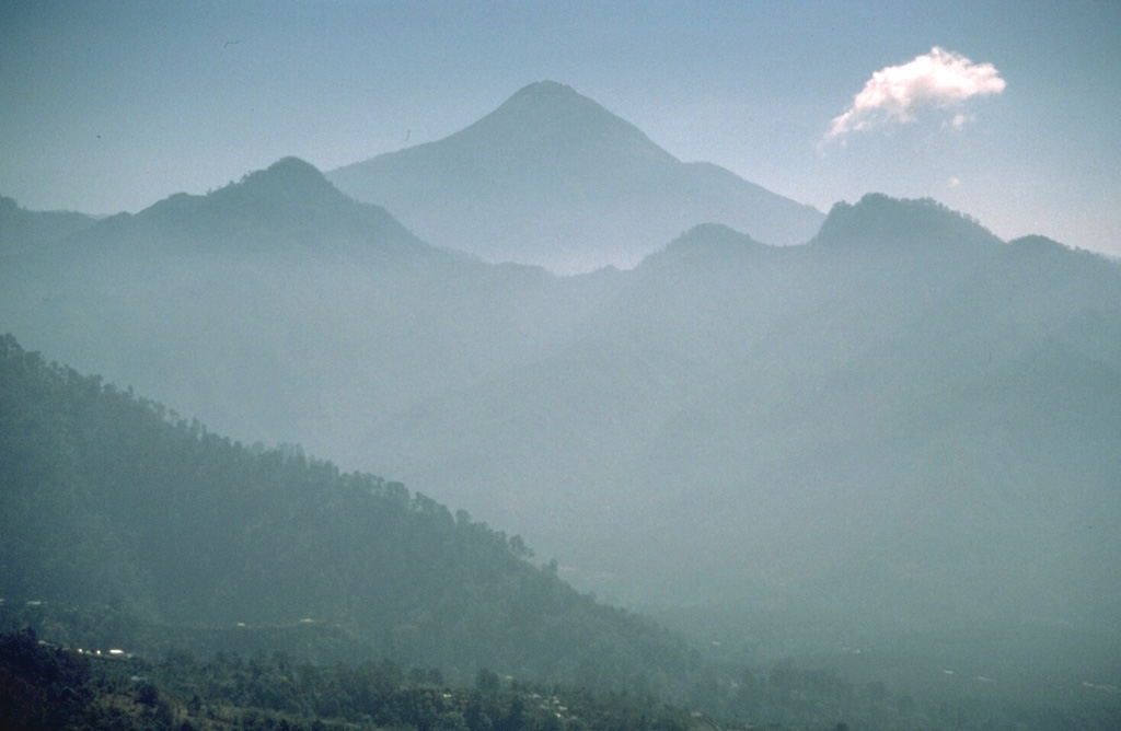 Tajumulco is seen here from the NW from the slopes of Tacaná volcano, which lies along the México/Guatemala border. A lava flow from the NW summit traveled NW down a deep valley on the flank.  Photo by Norm Banks, 1987 (U.S. Geological Survey).