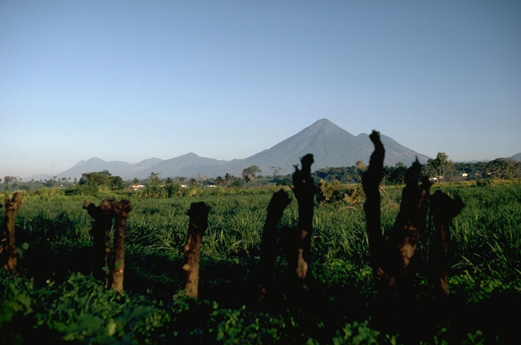 Volcán Atitlán rises above the Pacific coastal plain of Guatemala. Tolimán is the lower peak to the right of the summit. The volcanic highlands of Guatemala are seen here from the SE with Volcán Santo Tomás on the far left, 35 km to the NW of Atitlán. Photo by Lee Siebert, 1988 (Smithsonian Institution).