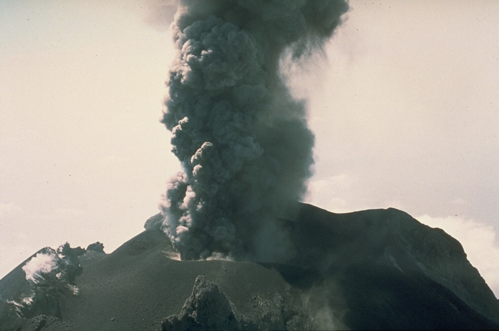 An ash plume rises from the summit crater of Fuego in this March 1978 photo. Intermittent minor explosive eruptions took place from 11 September 1977 to 8 August 1979. The eruptions sometimes produced pyroclastic flows and lava flows, and originated from multiple vents in the summit crater. Photo by Dick Stoiber, 1978 (Dartmouth College).