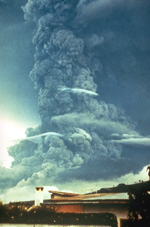 A large ash plume towers above Fuego in October 1974 as pyroclastic flows travel down the eastern flank (left). This was the largest Fuego eruption since 1932 at the time, and produced pyroclastic flows that traveled up to 7 km down the E, SE, SW, and W flanks. Prevailing winds distributed ashfall primarily to the SW, in the opposite direction from this view. Photo by William Buell, 1974.