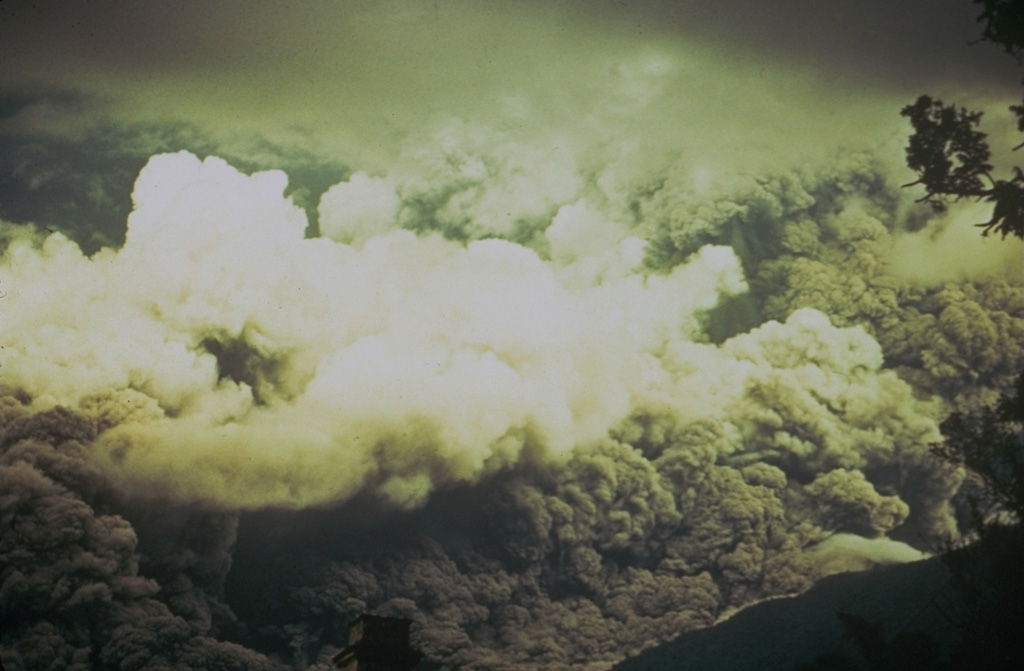 Ash rises above a pyroclastic flow racing down the eastern flank of Fuego in October 1974 that fills the entire field of view. The direction of movement of the pyroclastic flow was from right to left. Pyroclastic flows of comparable magnitude also traveled down the W and SW flanks. Photo by William Buell, 1974.