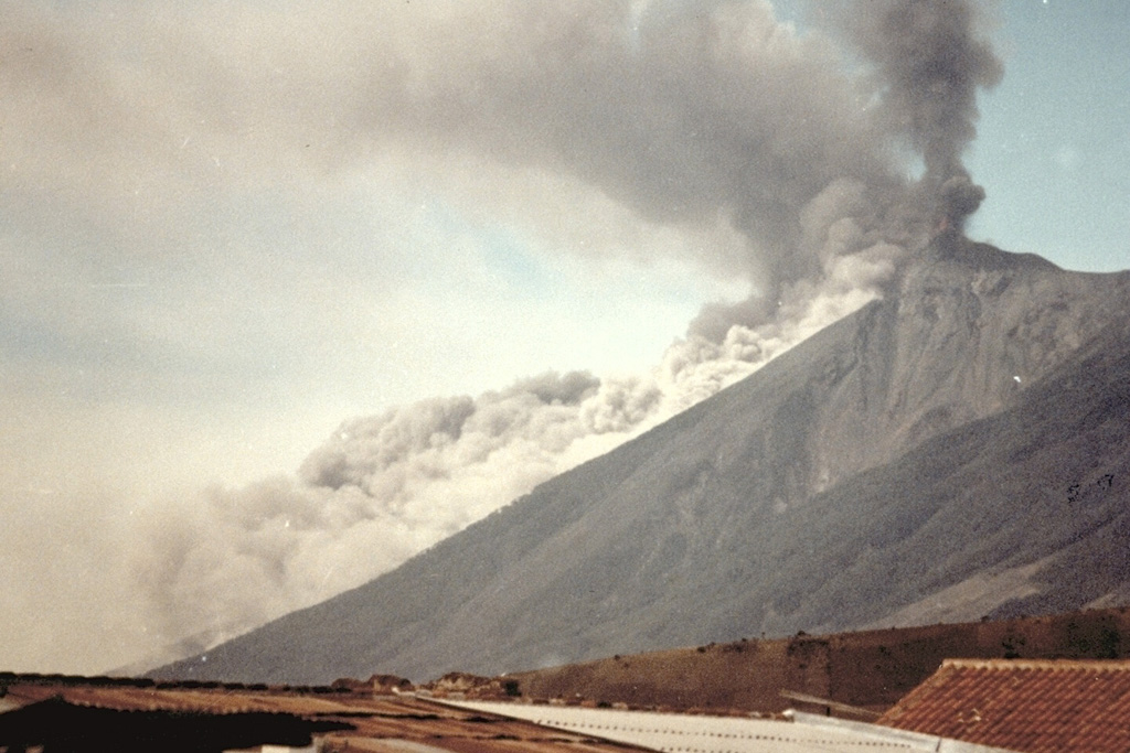 A pyroclastic flow descending the east flank of Fuego on 8 January 1979, is viewed from the city of Antigua Guatemala to the NE. Intermittent explosive eruptions had been occurring since September 1977 and lasted until 8 August 1979. Photo by Paulino Alquijay, 1979 (courtesy of Pete Newton).