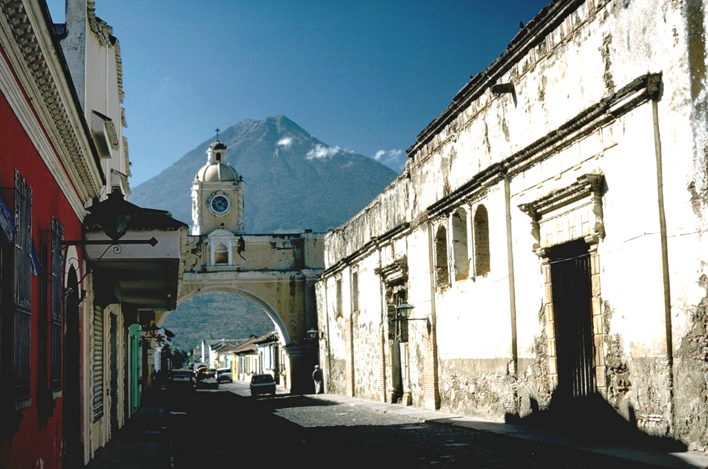 Volcán de Agua behind the historical colonial city of Antigua Guatemala and is one of three large volcanoes surrounding the town. The capital city of Guatemala was moved here following a catastrophic mudflow from Agua in 1541 that destroyed the former capital city, now known as Ciudad Vieja. Photo by Lee Siebert, 1988 (Smithsonian Institution).