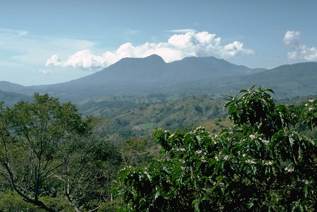 Tecuamburro, seen here from the north, is a small lava dome complex of mostly Pleistocene age. The smoother left flank consists of younger lava domes that were constructed during the late Pleistocene or early Holocene within a horseshoe-shaped, east-facing scarp. The scar resulted from structural failure of the older Miraflores edifice (right). Photo by Lee Siebert, 1988 (Smithsonian Institution).