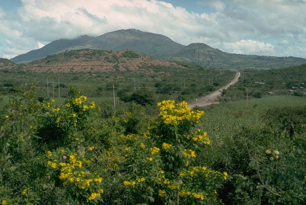 Ipala is part of a cluster of closely spaced small stratovolcanoes and scoria cone fields in SE Guatemala. The summit has a 1-km-wide crater containing a lake. The eastern flank, seen here from the SW, contains a line of Holocene scoria cones and lava flows. Monte Rico is the scoria cone on the south flank (right).  Photo by Lee Siebert, 1993 (Smithsonian Institution).