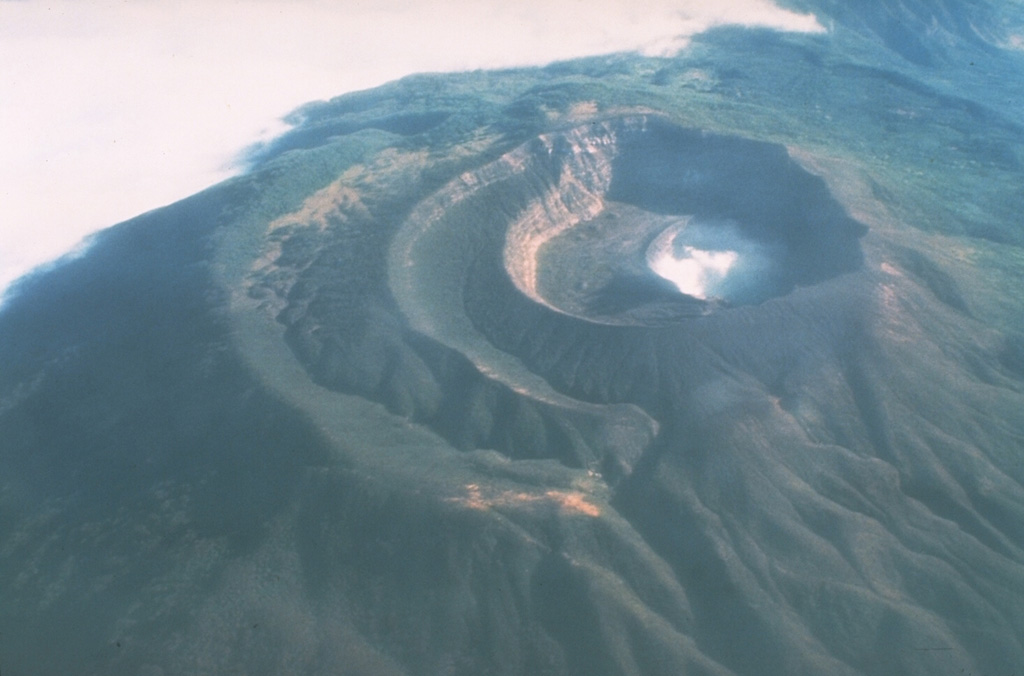 Santa Ana has four nested craters at its summit, seen here from the SW. A series of flank vents and cones have formed along a 20-km-long fissure system that extends from the lower NNE flank to the San Marcelino and Cerro Chino scoria cones on the SE flank. Historical eruptions have been recorded since the 16th century and have largely consisted of small-to-moderate explosions from both summit and flank vents. Photo by Mike Carr, 1982 (Rutgers University).