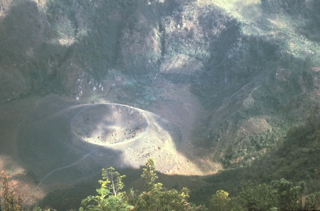 This scoria cone on the floor of the Boquerón summit crater at San Salvador was built during an eruption that began on 6 June 1917 on the upper north flank of Boquerón. A chain of scoria cones formed, and a lava flow traveled to the northwest, cutting the railroad between Quezaltepeque and Sitio del Niño. The Boquerón summit crater lake began to boil by 10 June and disappeared by 28 June, after which this small cone (Boqueroncito) formed on the crater floor. Photo by Mike Carr, 1979 (Rutgers University).