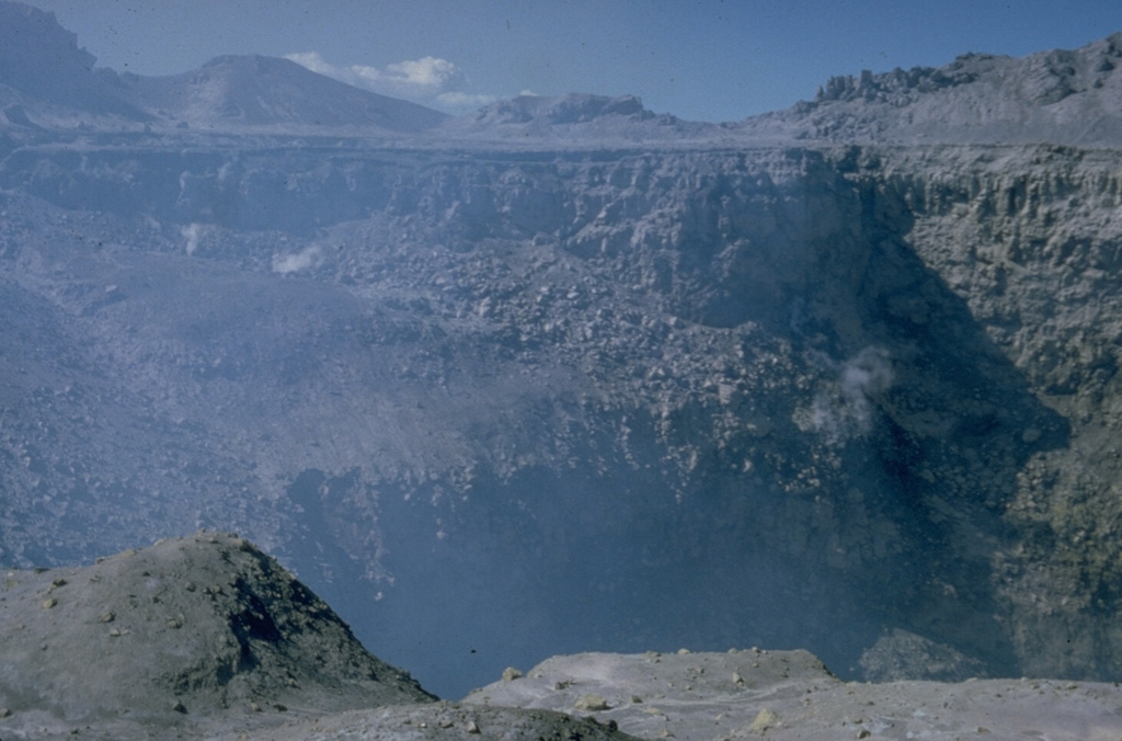 The summit of San Miguel volcano contains a deep crater whose morphology has been frequently modified by historical eruptions.  In 1586 the volcano already had a truncated summit; before then the volcano was said to have had a sharp peak.  In 1866 the crater was 600 m wide and 320 m deep and contained a subcrater on the ENE side.  A cinder cone that formed at the NE side of the crater in 1884 had largely disappeared by 1924, and a ring plain on the crater floor was largely gone by 1949. Photo by Dick Stoiber, 1965 (Dartmouth College).