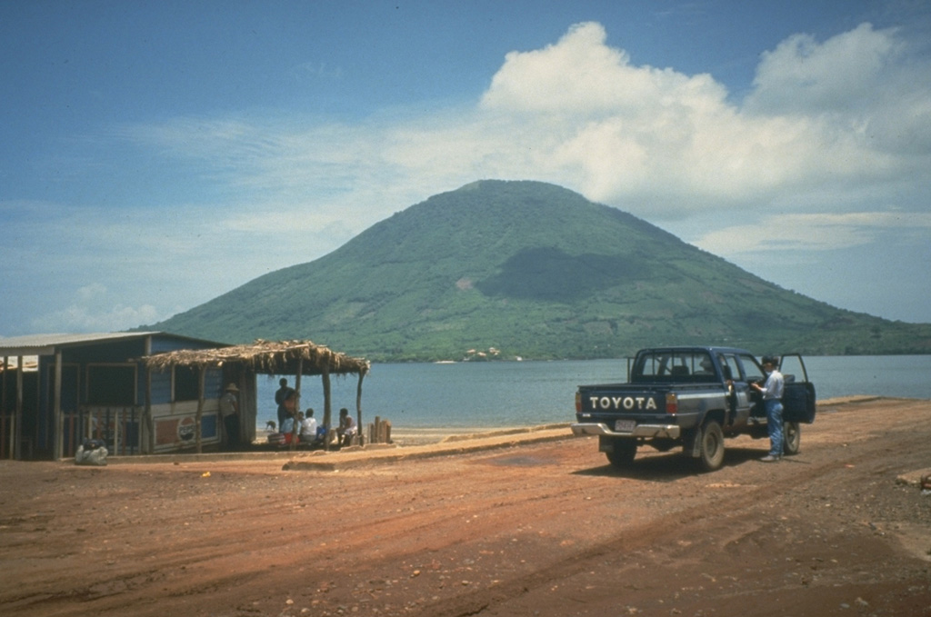 The morphologically youthful Isla el Tigre is a small, 5-km-wide island located south of Isla Zacate Grande in the Gulf of Fonseca.  The conical 783-m-high basaltic stratovolcano, viewed here from the NE across a narrow 2-km-wide strait from Zacate Grande, is the southernmost volcano of Honduras.  Photo by Mike Carr, 1991 (Rutgers University).