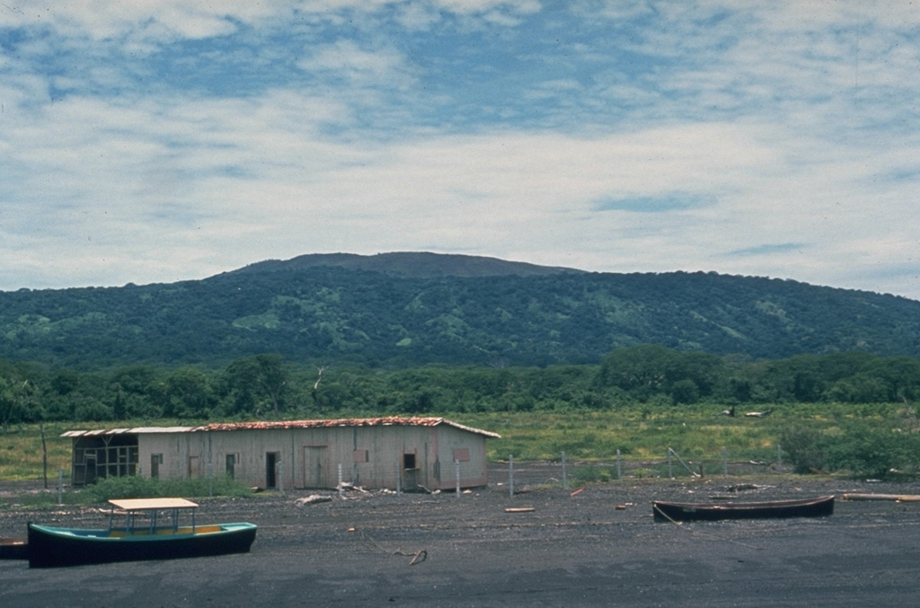 The profile of Cosigüina is not particularly impressive when viewed from its NE flank along the coast of the Gulf of Fonseca near the town of Potosí.  The broad low-angle slopes of Cosigüina rise only 872 m above the coast and give little hint of the dramatic caldera that cuts the summit.  Pyroclastic flows from the 1835 eruption reached the northern coast of the 20-km-wide Cosigüina Peninsula and formed new ephemeral islands in the Gulf of Fonseca. Photo by Dick Stoiber, 1978 (Dartmouth College).