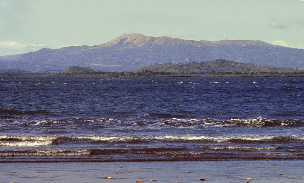 The broad Cosigüina stratovolcano (also spelled Cosegüina), is seen here from the SE across the Gulf of Fonseca.  Cosigüina is the NW-most of a chain of active volcanoes stretching across Nicaragua.  The 872-m-high volcano is truncated by a 2 x 2.4 km wide caldera that is filled by a lake.  In 1835 Cosigüina was the source of Nicaragua's largest historical eruption, which produced detonations heard as far away as Guatemala.  Pyroclastic flows and surges reached the Gulf of Fonseca and produced ephemeral islands. Photo by Jaime Incer.