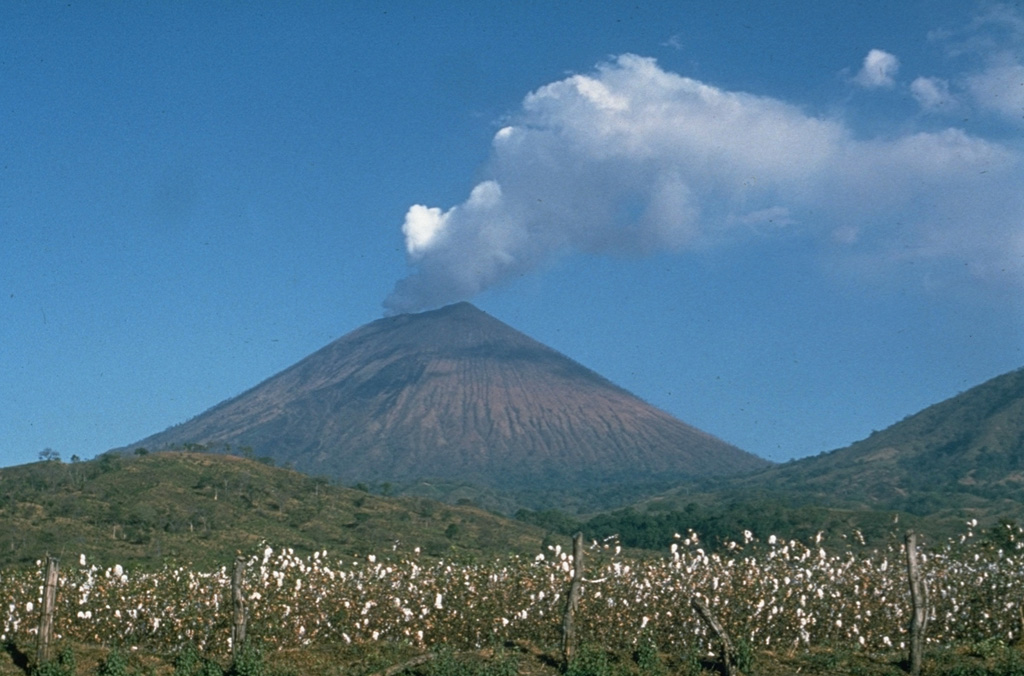 A strong steam plume pours from the summit crater of San Cristóbal volcano in this March 1976 view from the NW.  Mild explosive eruptions during March 9-16, 1976 were the first since 1971.  In February 1972 part of the crater floor began subsiding, ultimately leading to formation of a collapse pit in March 1976.  By December 1976 the pit had deepened to 90 m and incandescence was visible after dark. Photo by Dick Stoiber, 1976 (Dartmouth College).