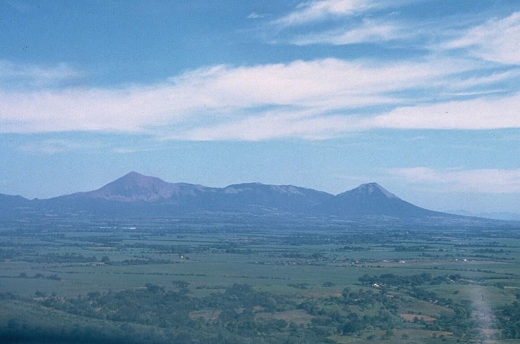This low-angle aerial view from the south shows the profile of the Telica volcanic complex, which consists of several interlocking cones and vents with a general NW alignment.  Telica itself, the high peak at the left, is a steep-sided cone with a 700-m-wide double crater.  El Liston, immediately E of Telica (at center), has several nested craters.  Santa Clara volcano is the symmetrical cone at the right. Photo by Dick Stoiber, 1972 (Dartmouth College).