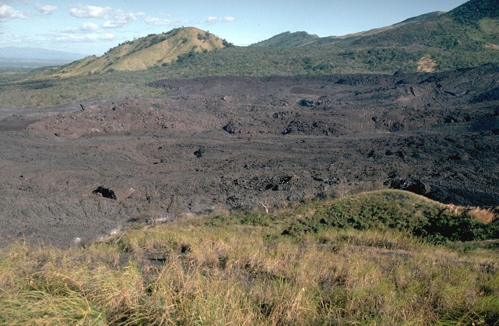 Lava flows from the 1995 eruption of Cerro Negro traveled to the NNE, overtopping earlier flows from eruptions in 1923, 1947, and 1957.  The 1995 flows traveled a maximum distance of more than 2 km from a new vent within the 1992 summit crater.  The flows mostly were emplaced between November 22 and December 2.  They covered an area of 0.65 km2, and individual flow lobes had thicknesses of 2 to 10 meters.  Photo by Britt Hill, 1995 (Southwest Research Institute).