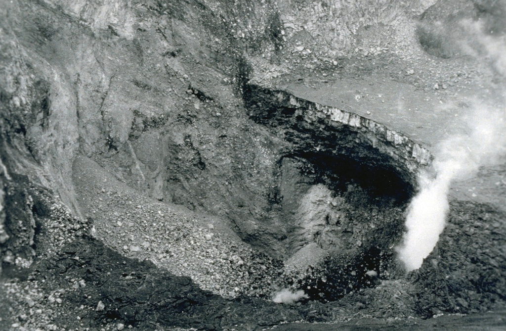 A small eruption occurred from Santiago crater on February 15, 1987 following blockage of the vent by landslides in November and December 1986.  The small eruption ejected ash and blocks, which fell back into the bottom of the vent.  Additional collapses took place on February 20, and the circular vent continued to produce small eruptions after February 22.  This photograph of Santiago's inner crater (180 m in diameter and 72 m deep) was taken after the collapse events of late 1986 and early 1987.  Photo by Douglas Farjado, 1987 (INETER).