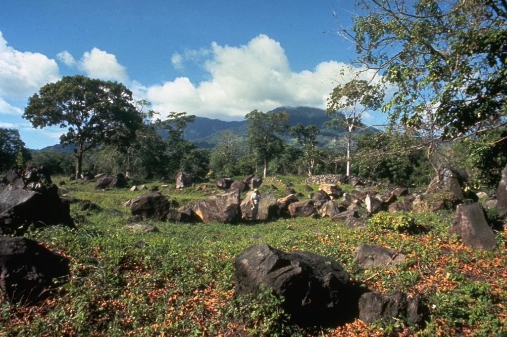 These angular boulders are part of a debris-avalanche deposit that originated from the south side of Mombacho volcano (seen in the background), most likely in 1570 CE.  The avalanche traveled 13 km from Mombacho, and destroyed a village, killing 400 people. Photo by Jaime Incer, 1972.