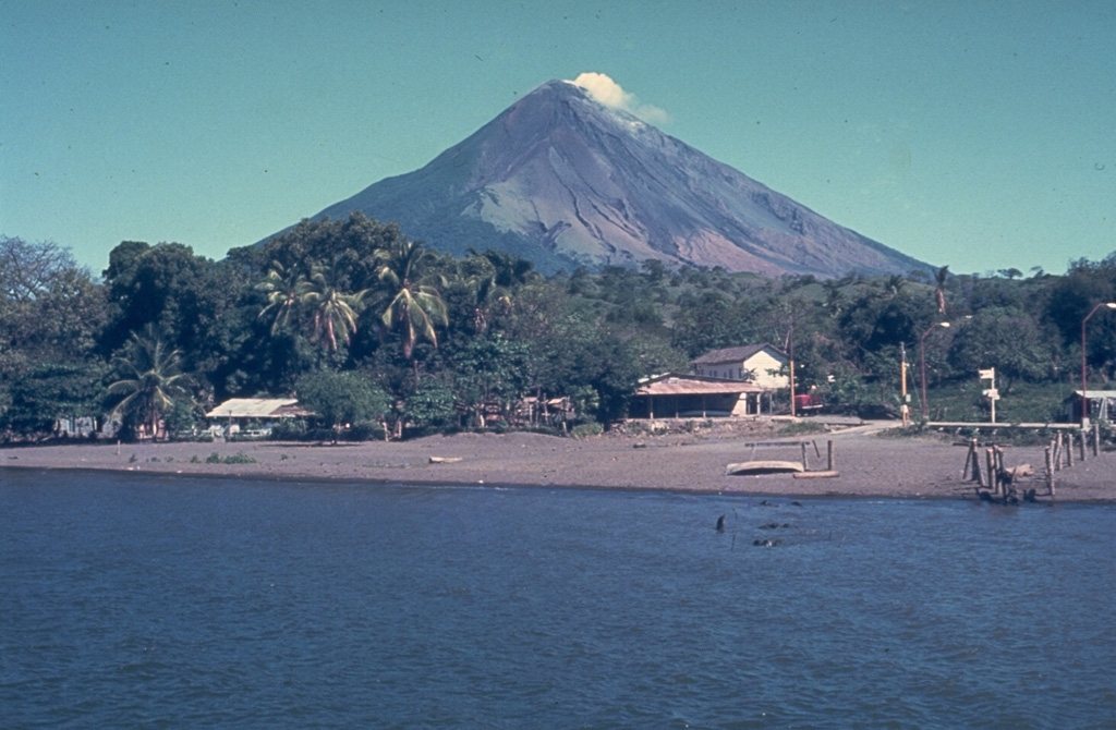 Concepción is one of Nicaragua's most active volcanoes. It forms the NW half of Ometepe island in Lake Nicaragua and is seen here from the SE from the isthmus connecting it to Madera volcano, which forms the SE end. Spatter cones, and scoria cones have formed during flank eruptions. Concepción has had frequent recent moderate explosive eruptions, many of which have originated from a summit crater. Photo by Jaime Incer.