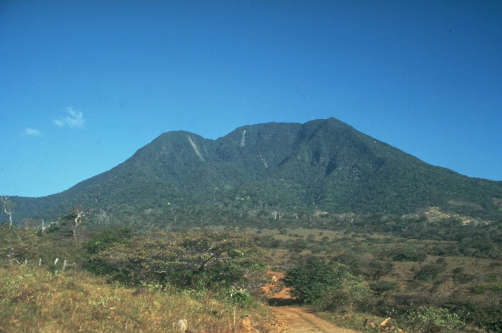 The highest peak of the Orosí volcanic complex is Volcán Cacao, which is seen here from the SW. The summit contains a scarp on the SW as a result of edifice collapse. Orosí is one of a cluster of four eroded and vegetated cones in the Guanacaste Range at the NW corner of Costa Rica.  Photo by Cindy Stine, 1989 (U.S. Geological Survey).