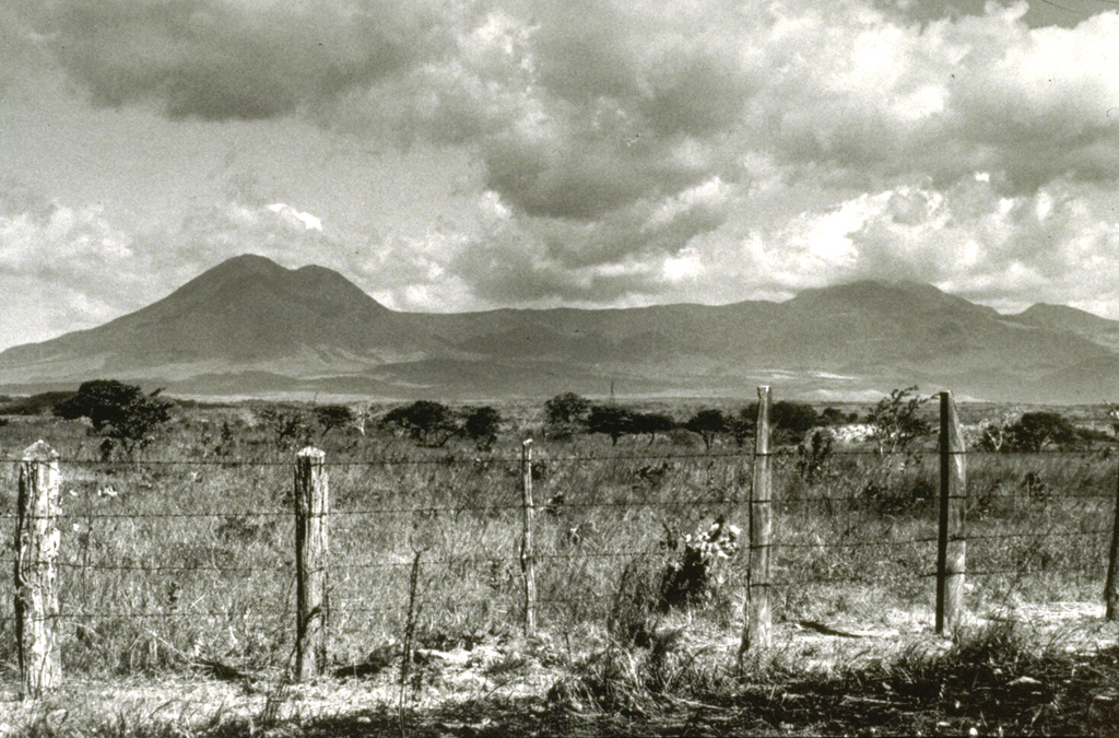 The Orosí volcanic complex is seen here from the north, with Orosí to the right and Volcán Cacao, the highest peak of the complex, to the left. Orosí is one of a cluster of four eroded and vegetated cones in the eastern part of Guanacaste National Park, NW Costa Rica. Photo by William Melson (Smithsonian Institution).