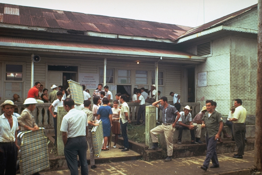 Officials bring supplies to residents evacuated as a result of the 1968 Arenal eruption. The village of Tabacón was nearly destroyed by ballistic ejecta produced by the powerful explosions at the onset of the eruption on 29 July. The town of Pueblo Nuevo was then established west of the area devastated by the explosions.  Photo by Tom Simkin, 1968 (Smithsonian Institution).