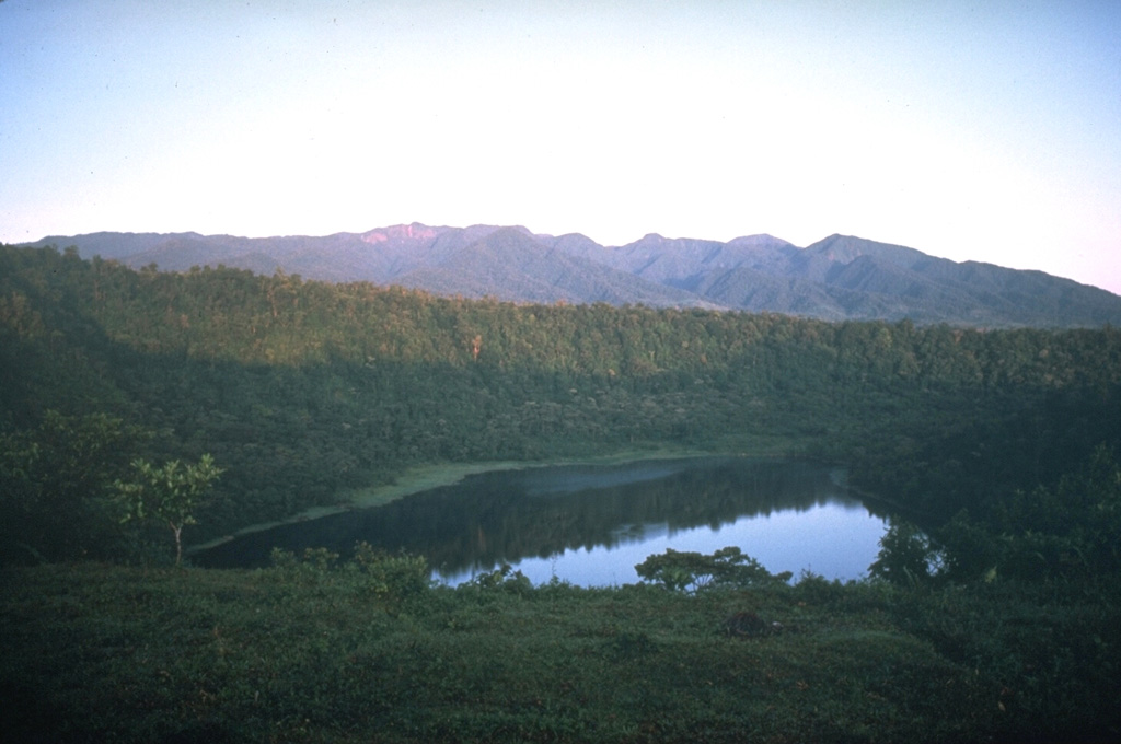 The Platanar volcanic complex on the horizon is the NW-most volcano in the Cordillera Central of Costa Rica. The complex consists of Platanar and Porvenir, which formed within the Chocosuela caldera. This view is from the east with the Hule maar, located about 11 km north of the Poás summit, in the foreground. Photo by Mike Carr, 1983 (Rutgers University).