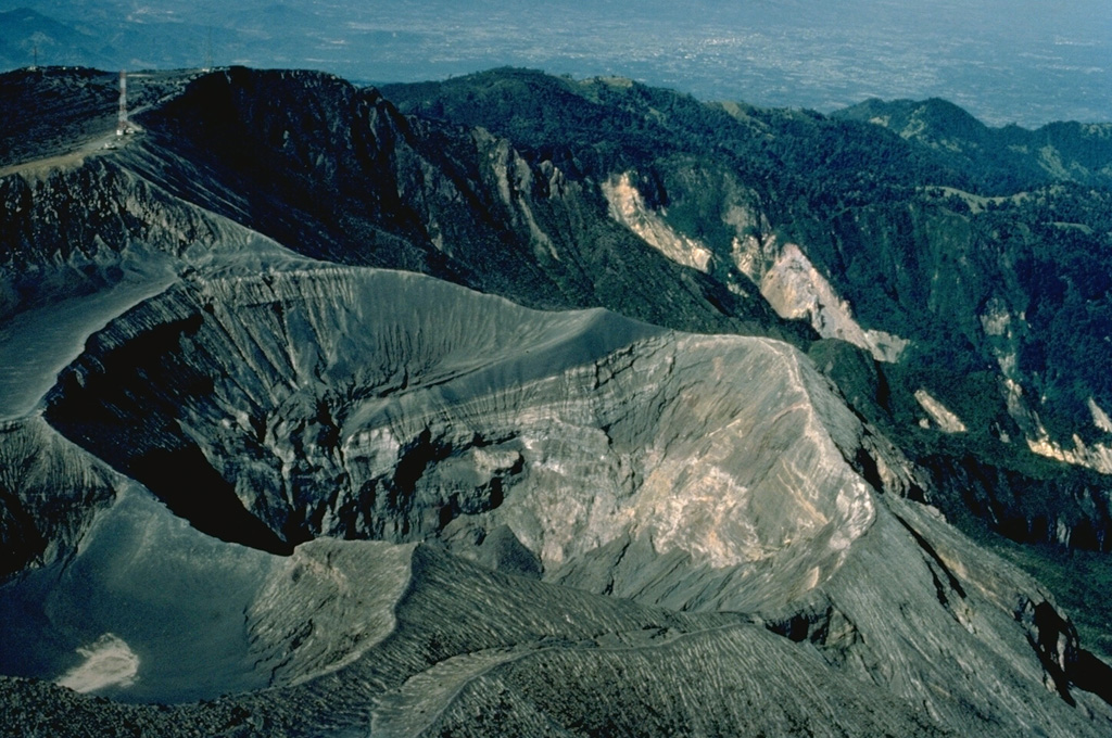 Irazú, Costa Rica's highest volcano, rises to 3432 m east of the capital city of San José.  The volcano is vegetated to within a few hundred meters of its broad summit crater complex.  At least 10 satellitic cones are located on the south flank of Irazú.  The focus of eruptions at the summit crater complex has migrated to the west towards the historically active crater, which contains a small lake.  Ashfall from its last major eruption during 1963-65 caused significant disruption to San José and surrounding areas.    Copyrighted photo by Katia and Maurice Krafft, 1983.