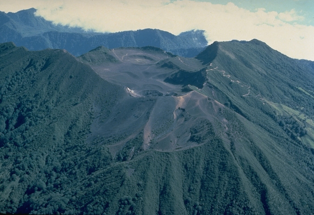 The summit crater complex of Turrialba, Costa Rica's 2nd-highest volcano, is seen here from the SW.  Three overlapping summit craters are located at the apex of a large 2 x 4 km summit depression that is widely breached to the NE.  The massive stratovolcano had four explosive eruptions during the past 2000 years.  These produced pyroclastic flows and surges that devastated areas currently used for agricultural purposes.  The most recent eruptions of Turrialba took place during the 19th century. Copyrighted photo by Katia and Maurice Krafft, 1983.