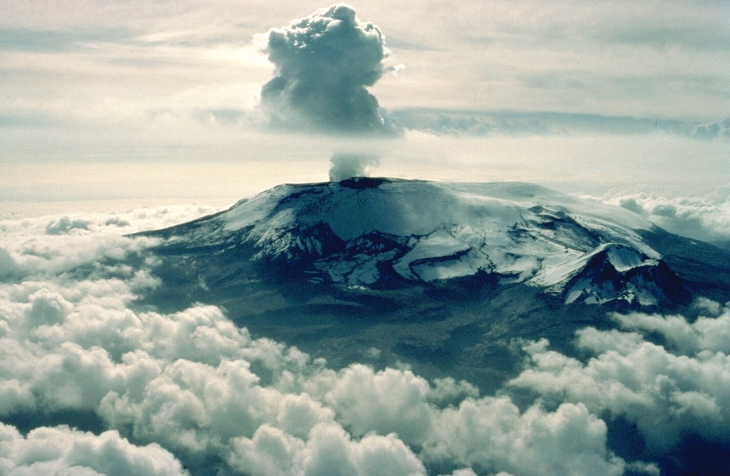 The catastrophic 1985 eruption of Nevado del Ruiz began with moderate phreatic explosions on September 11.  On November 13 a relatively moderate explosive eruption occurred, producing pyroclastic flows and surges that melted part of the summit icecap.  These caused major lahars that devastated Amero and other towns on the flanks of the volcano, killing more than 23,000 people.  Intermittent minor ash emissions, such as this one on November 28, and occasional stronger phreatomagmatic eruptions continued until July 1991. Copyrighted photo by Katia and Maurice Krafft, 1985.