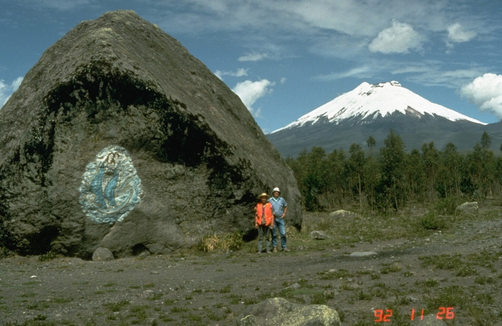 This massive boulder on the SW side of Cotopaxi was carried in a lahar, possibly during a major eruption in 1877. Scale is provided by volcanologists Minard Hall and Patty Mothes. More than 130,000 people live in areas subject to lahar risk from Cotopaxi. The 1877 eruption produced lahars that covered this valley, swept into eastern river drainages, and reached the Pacific Ocean along valleys to the NW. Photo by Tom Pierson, 1992 (U.S. Geological Survey).