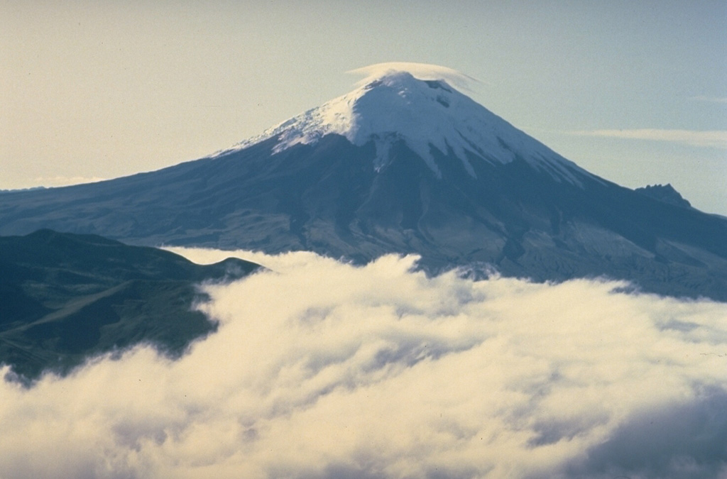 A combination of frequent eruptions, a high water budget locked up in its summit icecap, and its location atop the topographic axis of the Ecuadorian Andes make Cotopaxi a prime source of lahars (volcanic mudflows).  During historical time, lahars have swept drainages to the north along the Río Pita and Río Guayllabamba all the way to the Pacific Ocean and into the western Amazon basin down the Río Cutuchi to the SW and the Río Napo to the east.  More than 130,000 people occupy areas subject to lahar risk from Cotopaxi. Copyrighted photo by Katia and Maurice Krafft, 1983.