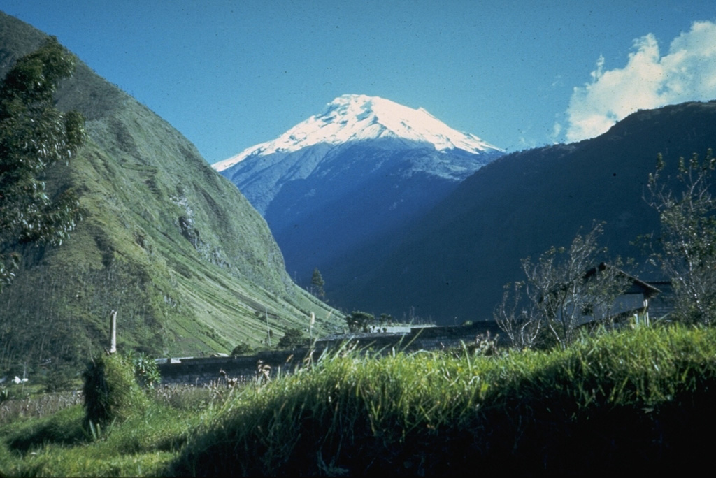 Snow-capped Tungurahua, seen from near the town of Baños on its northern flank, rises 3200 m above steep-walled canyons.  Historical eruptions, separated by long reposes, have produced powerful explosions, sometimes accompanied by pyroclastic flows and lava flows.  All historical eruptions have originated from the summit crater, and have typically lasted for several years.  The largest historical eruptions took place in 1886, 1916, and 1918. Photo by Minard Hall, 1976 (Escuela Politécnica Nacional, Quito).
