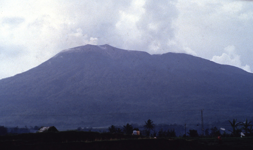 Gunung Talakmau, seen here above the western coastal plain of Sumatra from the NE. The volcano was constructed along a NE-SW line and rises more than 700 m above Pasaman to the SW. The NE-most and highest of three craters at the summit of Talakmau (left center) is filled by a lava dome. Anonymous, 1991.