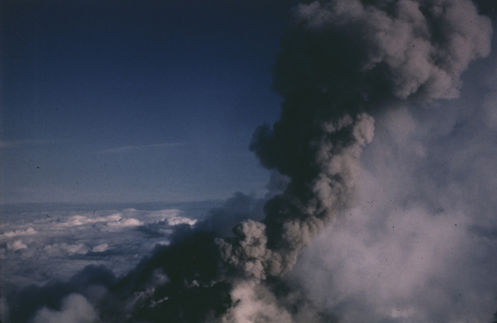 An ash plume rises from vents near the summit of Pavlof on 10 June 1987 in this view from the NNE. Intermittent explosive eruptions took place from vents at the summit and flanks from April 1986 until August 1988, and lava flows descended the flanks in several direction. One lava flow reached to within 600 m of Pavlof Bay and another descended to the saddle between Pavlof and Pavlof Sister. Photo by Harold Wilson, 1987 (Peninsula Airways).
