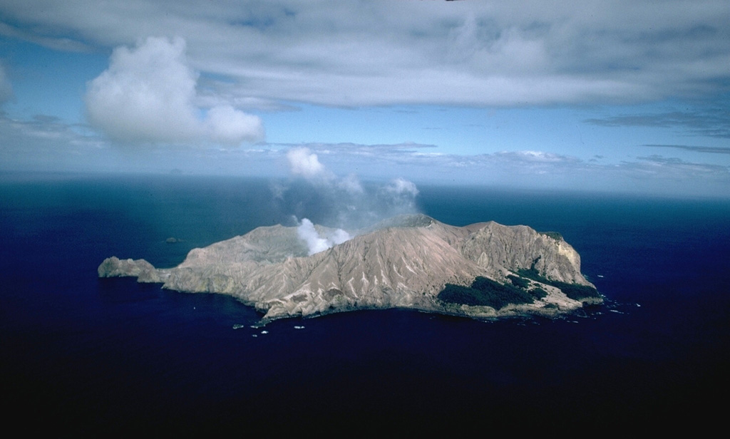 White Island (also called Whakaari), seen here from the NE, is a low (~300-m-high), 2 x 2.4 km wide, uninhabited island off the coast of New Zealand's North Island. This is one of New Zealand's most active volcanoes, with frequent explosive eruptions recorded since 1826 that have deposited tephra over the island, preventing the growth of vegetation in all but a few small areas along the coast. Copyrighted photo by Stephen O'Meara.