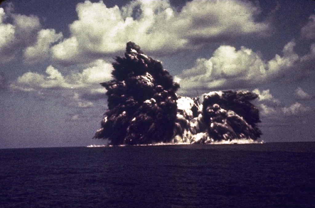 An explosion from the Beyonesu Rocks at the Myjinsho submarine caldera in Japan's central Izu Islands breaches the sea surface on 23 September 1952. These cock’s tail jets of blocks and ash are characteristic of shallow submarine explosions. This photo was taken 5 seconds after the explosion breached the sea surface; five minutes later the eruption was over and the sea was again calm. The suddenness of these powerful explosions proved to be fatal to 31 people on a research vessel that sailed over the vent the following day. Photo courtesy of Ryohei Morimoto (University of Tokyo), 1952.
