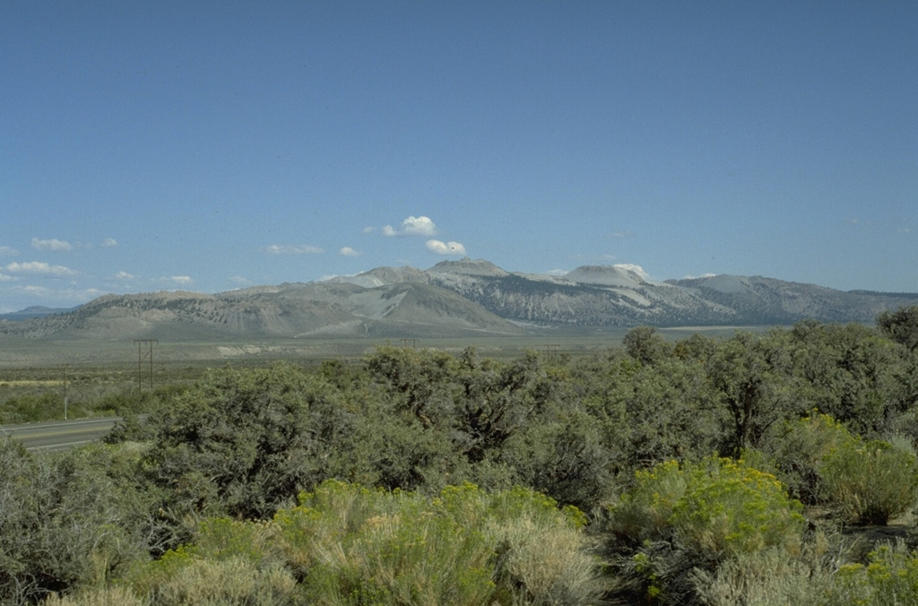 The Mono Craters volcanic field, seen here from the NW, is a 17-km-long arcuate chain of lava domes, lava flows, and tephra rings.  The latest eruptions took place about 600 years ago from several vents at the northern end of the chain, producing  rhyolitic lava domes and flows. Photo by Victoria Avery, 1992 (Smithsonian Institution).