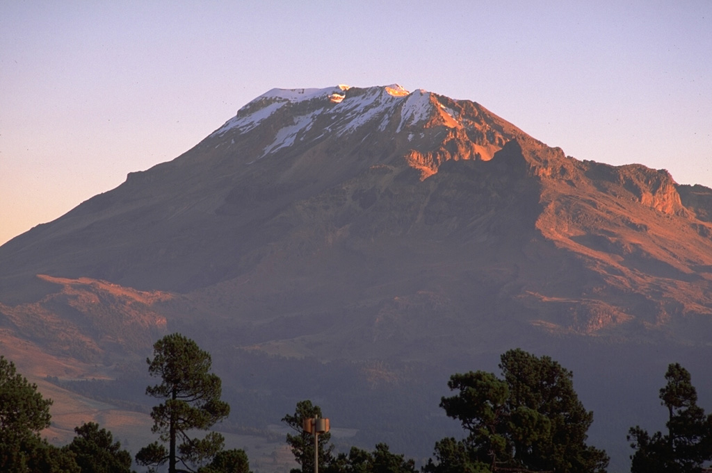 The northern end of the Iztaccíhuatl summit ridge is seen here from east of the Paso de Cortés to the south. A postglacial vent is located on the lower south flank of the volcano, north of the saddle between Iztaccíhuatl and Popocatépetl. Copyrighted photo by Stephen O'Meara, 1993.