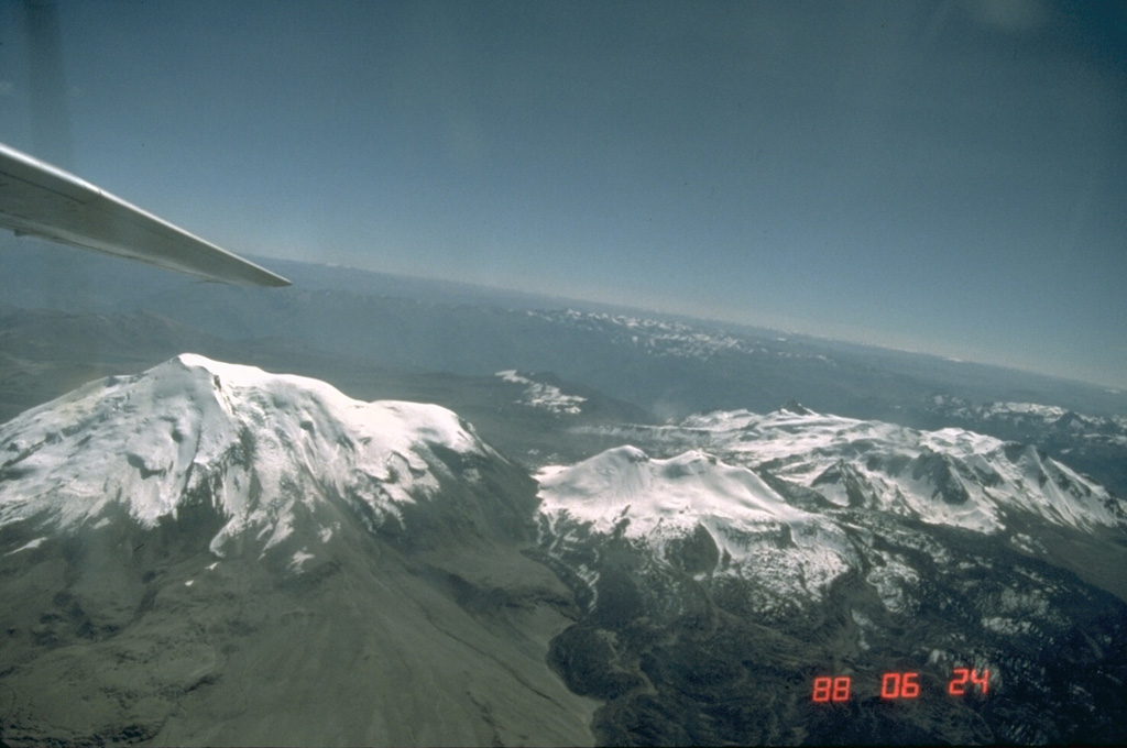 The Sabancaya volcanic complex, viewed here from the east, consists of 6288-m Ampato volcano (left), the eroded 6025-m-high Hualca Hualca volcano (right), and Sabancaya volcano proper (center), which was constructed on the saddle between the two older volcanoes.  The two older centers have produced morphologically youthful lava flows, but 5967-m-high Sabancaya is the only center to have erupted in historical time. Photo by Norm Banks, 1988 (U.S. Geological Survey).