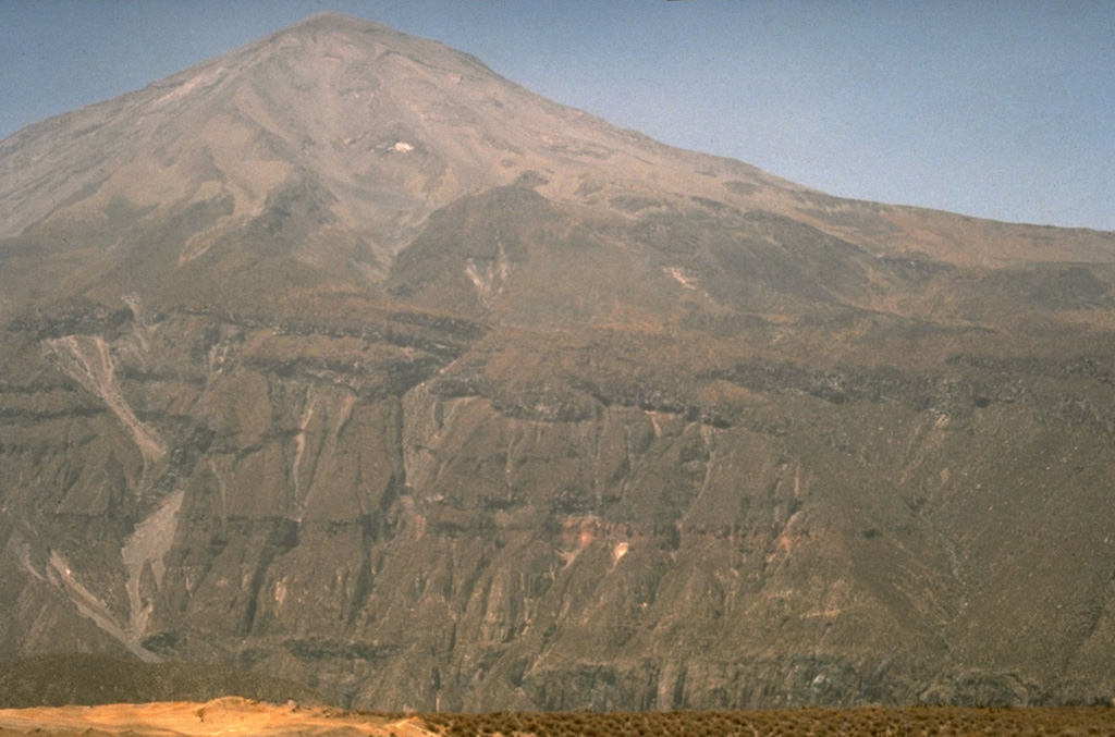 The Río Chillos on the NW side of El Misti volcano has excavated a steep-walled canyon that cuts the lower flanks of the volcano.  The NW flank of El Misti is somewhat dissected, in contrast to smoother slopes on other sides.  Prevailing winds have distributed a thick ashfall blanket to the NE that mantles the distal margins of youthful lava flows.   Photo by Norm Banks, 1987 (U.S. Geological Survey).