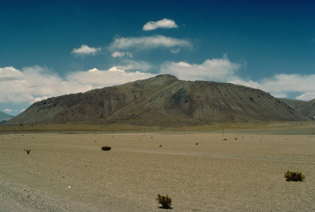 The steep-sided Chanka lava-dome complex, also referred to as Cerro Pabellón, is the most prominent feature on the lower western flank of Cerro del Azufre.  This volcano is the largest and youngest of a 50-km-long, NW-SE-trending chain of Chilean volcanoes just west of the Bolivian border, south of Salar Ascotán.  In addition to the Chanka lava dome, two other dacitic Holocene lava domes were erupted along a NW-SE line east of the summit ridge.  This marks the most recent activity of the Cerro del Azufre complex. Copyrighted photo by Katia and Maurice Krafft, 1983.