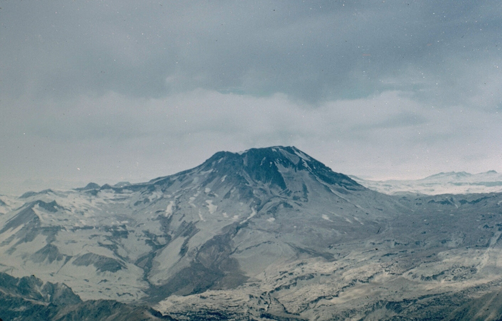 Volcán Descabezado Grande, seen here from the west, is a late-Pleistocene to Holocene stratovolcano with a 1.4-km-wide ice-filled summit crater.  The Holocene Alto de las Mulas fissure on the lower NW flank (out of view to the left) produced young rhyodacitic lava flows.  A lateral crater formed on the upper NNE flank in 1932, shortly after the end of the major 1932 eruption from nearby Quizapú volcano.  This was the site of the only historical eruption of Descabezado Grande.    Photo by Hugo Moreno (University of Chile).