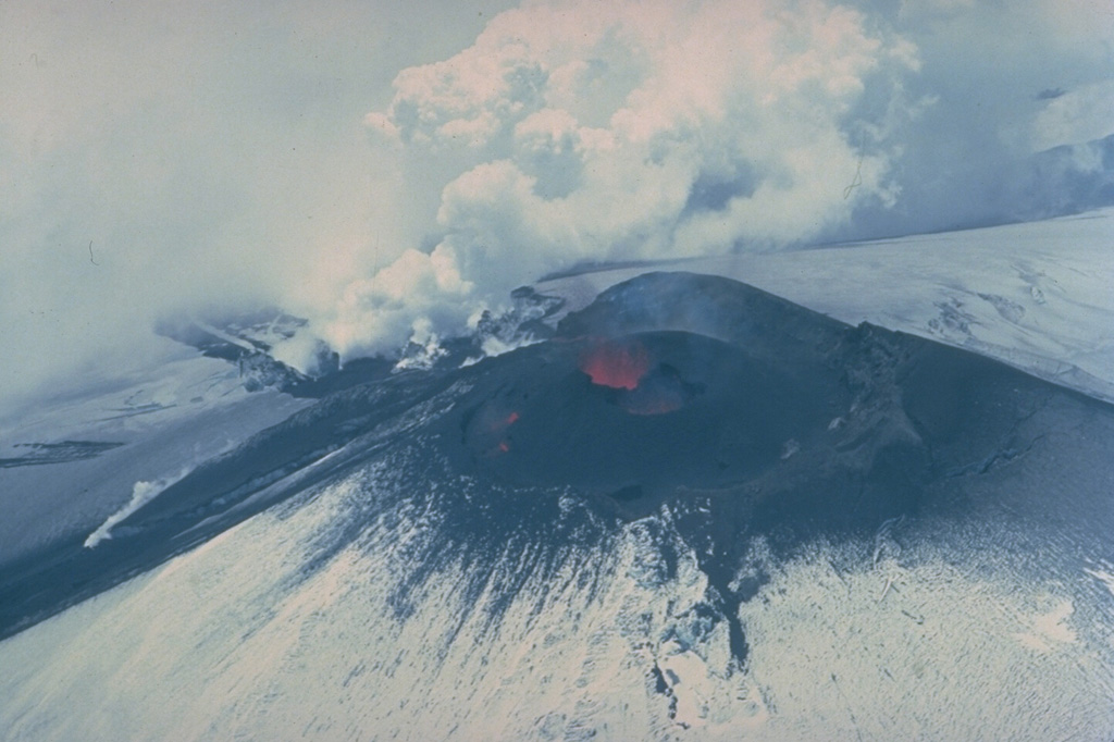 Lava fountaining from a lava lake at the NNE side of Villarrica's summit crater feeds steaming lava flows down the north and NE flanks in December 1984.  The 1984-85 eruption began in August.  Following intensified activity in October, the NE-flank lava flow melted a channel 50-m wide and 30-40 m deep and produced a 5-km-long avalanche.  Lava melted through the ice and flowed beneath the glacier before emerging onto the surface again on November 13, generating a 3-km-long avalanche and leaving a 150-m-long ice bridge. Copyrighted photo by Katia and Maurice Krafft, 1984.