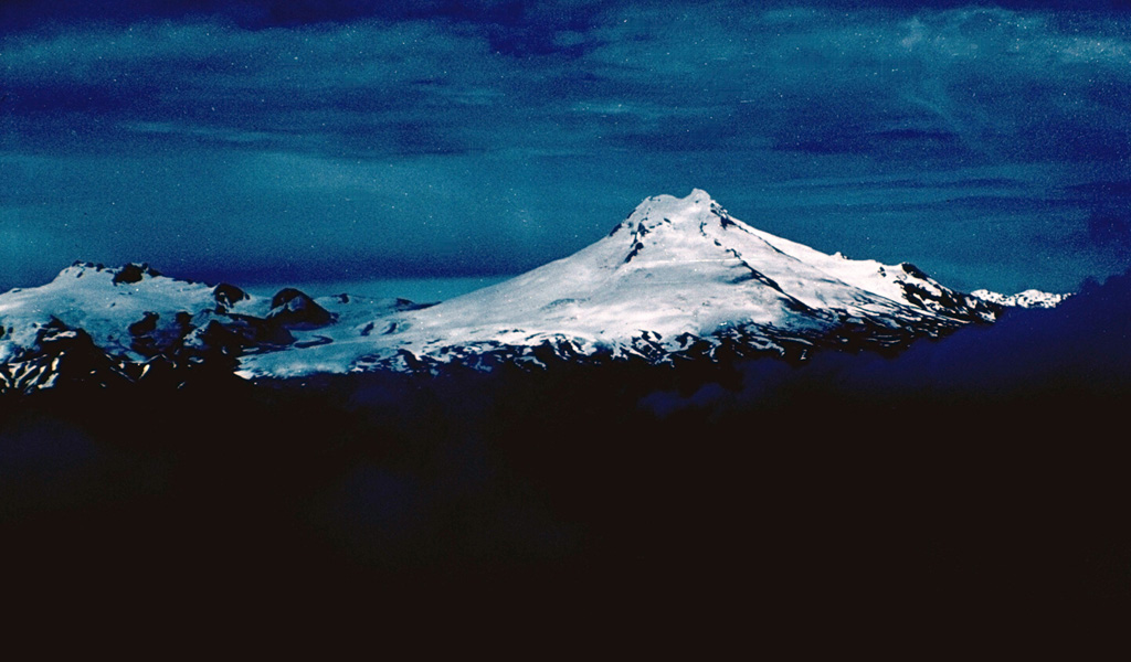 Volcán Macá, the highest volcano between Lanín and Lautaro, rises to 2960 m NW of Puerto Aisén.  Little is known of the geologic history of this glacier-covered stratovolcano, which contains a summit lava dome and flank cinder cones. Photo by John Davidson, University of Michigan (courtesy of Hugo Moreno, University of Chile).