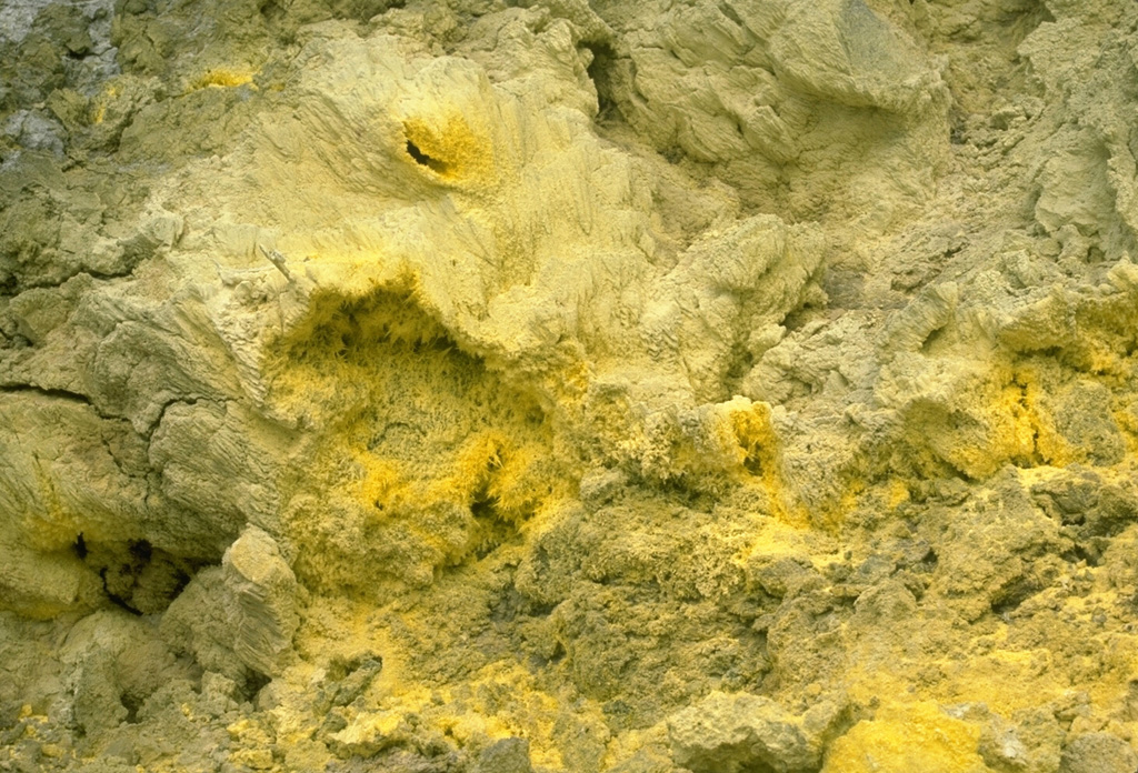 Sulfur crystals are deposited around fumarolic vents at Galway's Soufrière on the south flank of Soufrière Hills volcano.  Pyroclastic flows from a growing lava dome spilled over the south rim of the summit crater down the White River Ghaut valley and buried this frequently visited fumarolic area in April 1997. Photo by Lee Siebert, 1977 (Smithsonian Institution).